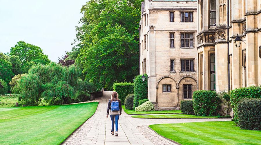 young woman walking through university campus